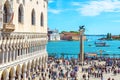 People visit the San Marco embankment in Venice, Italy. Doge`s Palace on left Royalty Free Stock Photo