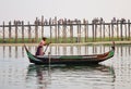 People visit U Bein Bridge by boat Royalty Free Stock Photo