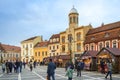 People visiting the Christmas market in Brasov. The Orthodox Church of the Birth of the Mother of God in the background