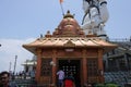 People visiting Lord Shiva temple and big lord Shiva statue at the back at Char dham Royalty Free Stock Photo