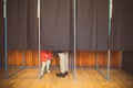 People vote in voting booth Royalty Free Stock Photo