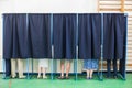 People voting in booths