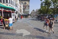 People on vrijdagmarkt near merry-go-round in Ghent