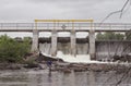 People wade in water by huge Chute Pond dam Royalty Free Stock Photo