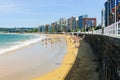 People wading on the beach in Gijon Spain Royalty Free Stock Photo