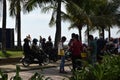 People wait on queue on bay walk to view the artificially face lifted beach coast line dumped with white dolomite sand. silhouett