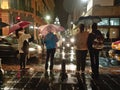 People wait to cross a street in Quito on a rainy night Royalty Free Stock Photo