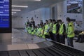 People waiting at the airport luggage