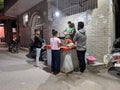 People are waiting at an Indian food stall