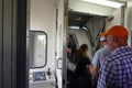 People waiting on a jetway to board an airplane