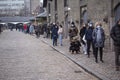 People waiting in line queued up for health screening for Coronavirus Covid-19 testing at city test center wearing medical protect