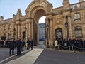 People waiting outside an old building in Paris