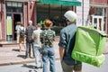 People waiting, standing in line, respecting social distancing to enter takeout restaurant or to collect purchases from