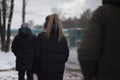 People are waiting for transport. Lot of people in winter stand at bus stop. Men and women are waiting for bus by road Royalty Free Stock Photo