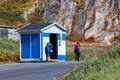 People waiting at a wooden bus stop in Sisimiut, Greenland.