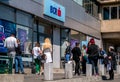 People waitting outside in front of a BCR bank branch