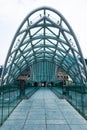 People waling along the Bridge of peace. The modern architecture and famous landmark in Tbilisi Georgia