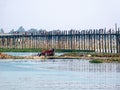 People walk across the famous U-Bein  Bridge in Burma Royalty Free Stock Photo