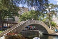 People walk across a metal bridge over the San Antonio River on the River walk In San Antonio, Texas. On September 25th, 2022