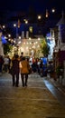 People walk in Alberobello old streets