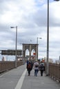 People Walk Along Brooklyn Bridge