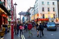 People walk along a busy shopping street in London Chinatown. Royalty Free Stock Photo