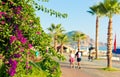 People walk along Cleopatra Beach in Alanya in hot summer day