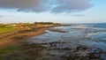 People walk along Echo Beach before sunset. Aerial Shot Of Tourists enjoy time before sunset at the popular beach in Royalty Free Stock Photo