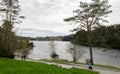 People walk along Eivindsvannet lake in Djupadalen public recreational and hiking area, Haugesund