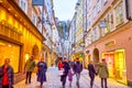 People walk along Getreidegasse street in Salzburg, Austria