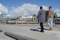 People walk along harbor edge Tauranga city waterfront playground
