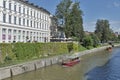 People walk along Ljubljanica river in Ljubljana, Slovenia