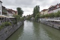 People walk along Ljubljanica river in Ljubljana, Slovenia Royalty Free Stock Photo