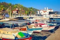 People walk along pedestrian bridge in yacht marina of Marmaris old town