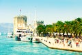 People walk along the picturesque pier of Trogir