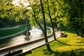 People walk around the city park during sunset in Royalty Free Stock Photo