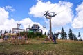 People walk around Medvedin mountain chairlift top station on sunny summer day Royalty Free Stock Photo