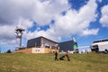 People walk around Medvedin mountain chairlift top station on sunny summer day Royalty Free Stock Photo