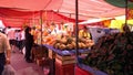 People walk, buy groceries and enjoy the ambience in a street market, after local authorities decreas