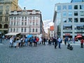 People walk in the center of Prague on a sunny day