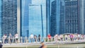 People walk in city pedestrian bridge with exterior modern build