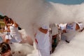 People Walk Through Cloud Of Foam At Bubble Palooza Event