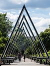 People walk down the original alley of architects with giant triangles. Green domes with golden Orthodox crosses of Church