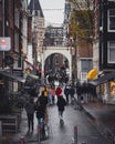 People walk down Staalstraat on a cold, autumn day in Amsterdam.