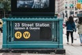 People walk by the entrance to 23 Street subway station in New York, USA.