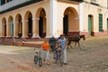 People walk in front of the Brunet palace in Trinidad, Cuba. Royalty Free Stock Photo