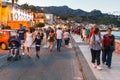 People walk in Giardini Naxos in evening