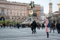 People walk on the main square of the city of Milan - Piazza del Duomo near the monument to the first king of Italy Vittorio