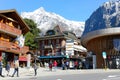 People walk next to the Alpine buildings