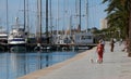 People walk next to the sea after they were allowed out to exercise for the first time in seven weeks wider